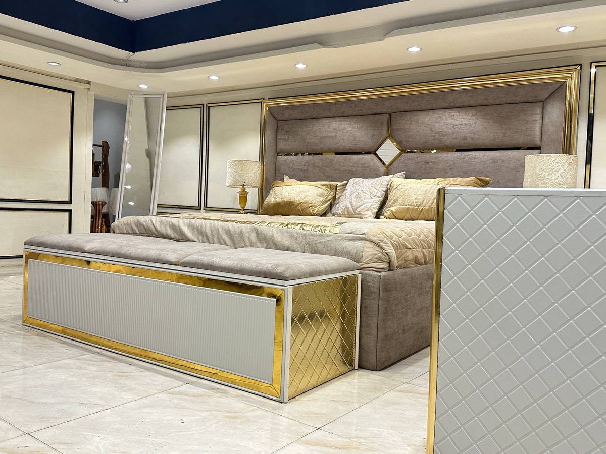Luxury Upholstered Bed with Gold Accents and Storage Ottoman