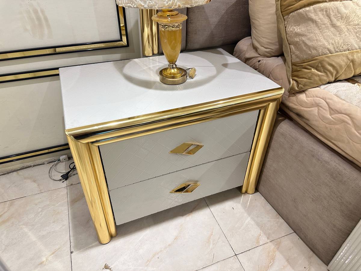 Luxury Upholstered Bed with Gold Accents and Storage Ottoman