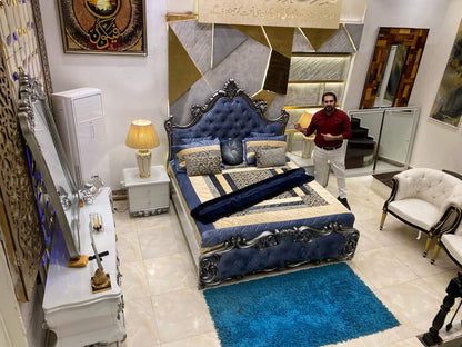Luxurious Blue Velvet Upholstered Bed with Ornate Nightstand and Mirror