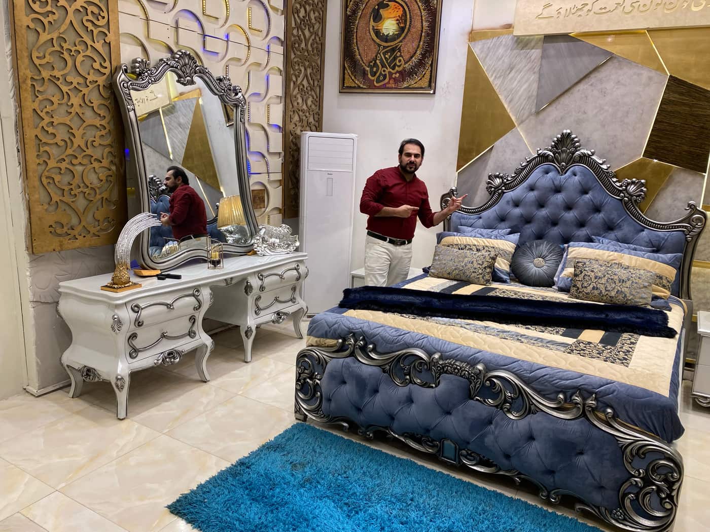 Luxurious Blue Velvet Upholstered Bed with Ornate Nightstand and Mirror