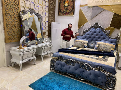 Luxurious Blue Velvet Upholstered Bed with Ornate Nightstand and Mirror